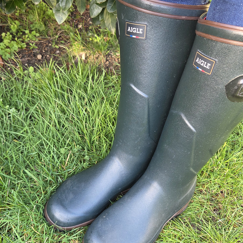 Close up image of woman wearing ladies Aigle Parcours 2 ISO wellington boots in field