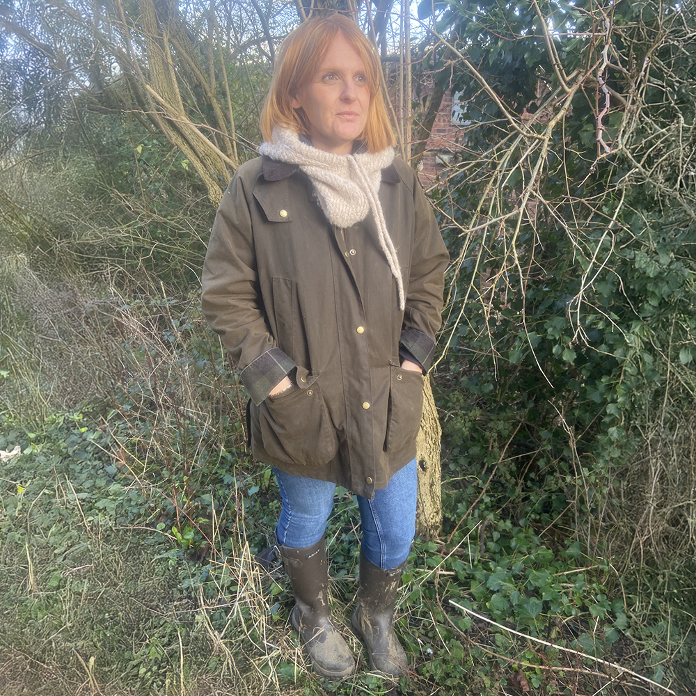 Woman wearing Ariat Woodtsock Wellies on a rainy day in mud