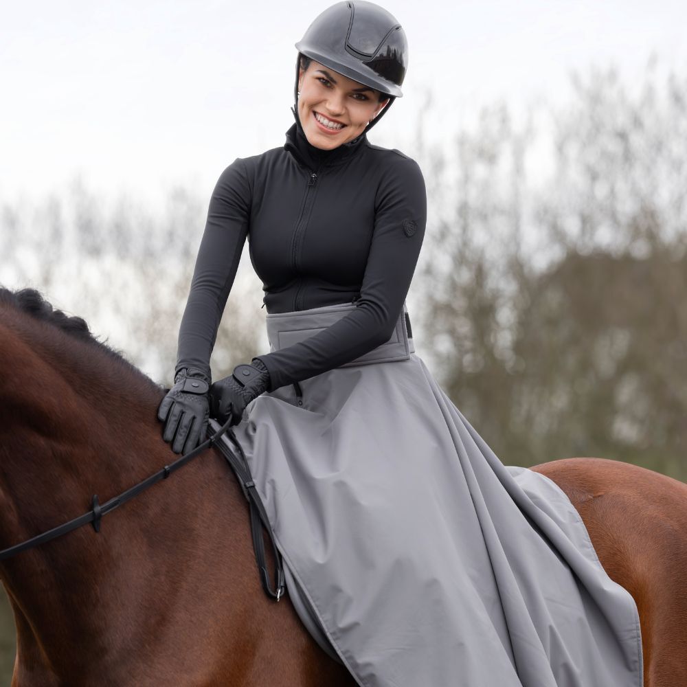 Female horse rider wearing thermal waterproof riding skirt