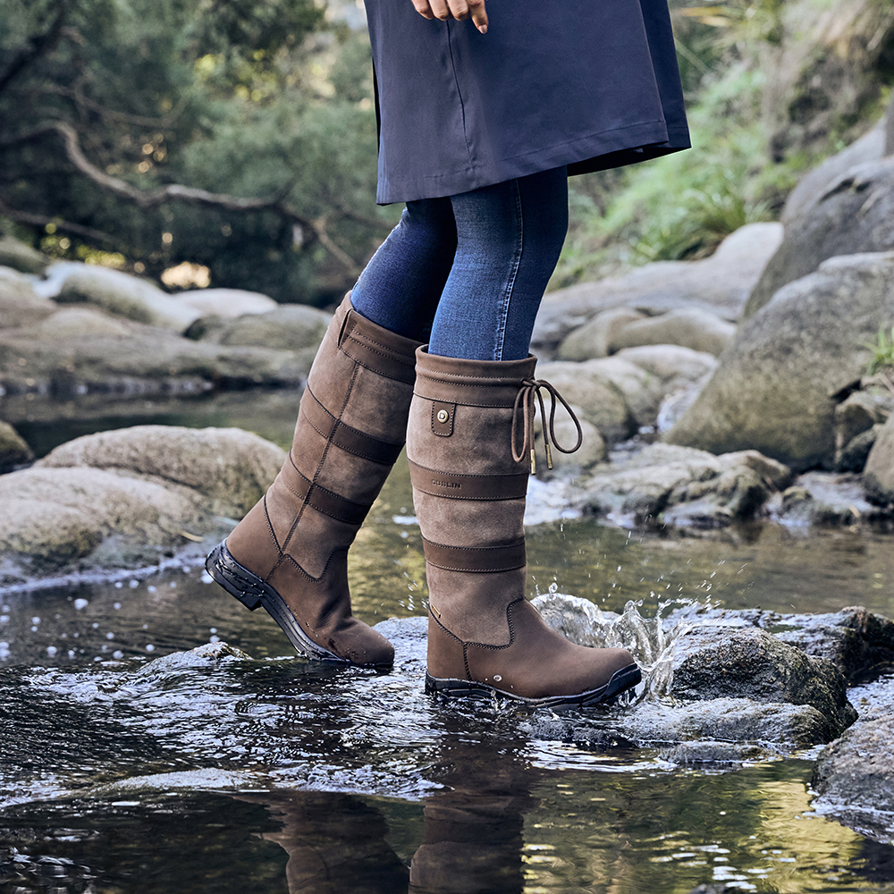 Woman wearing the Dublin River country boots in a stream