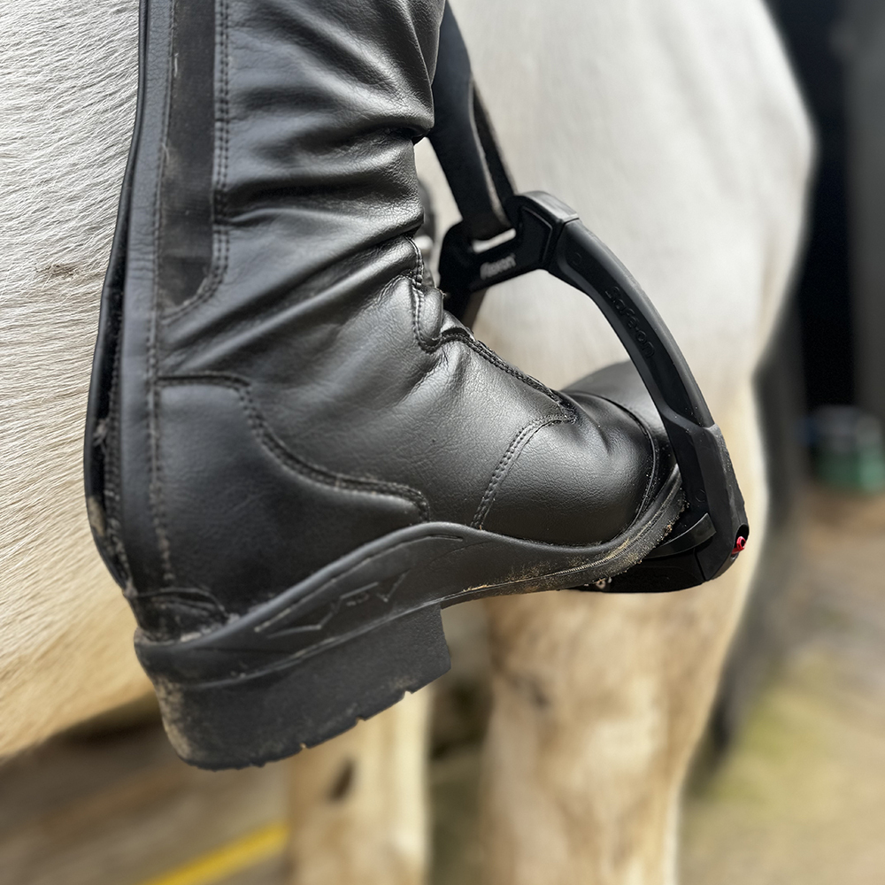Rider wearing Flex-On Safe-On stirrups with inclined ultra grip tread for stability and safety in the saddle