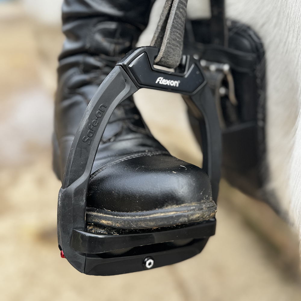 Flex-On Safe-On Stirrups with Incline Ultra Grip - All Black on saddle with rider's foot