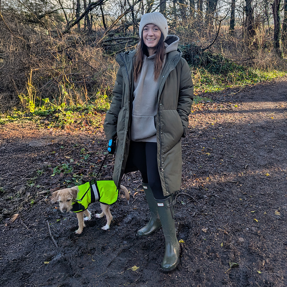 Woman walking dog in forest wearing Hunter Boots Downpour Wellies