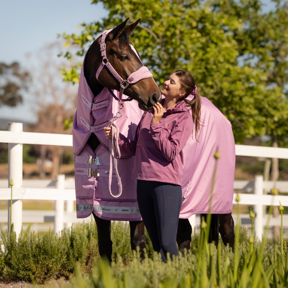 Horse in field wearing Fondant Pink Horse Rug - LeMieux Arika Spring Summer 2026 Horse in field wearing Fondant Pink Horse Rug - LeMieux Arika Spring Summer 2026