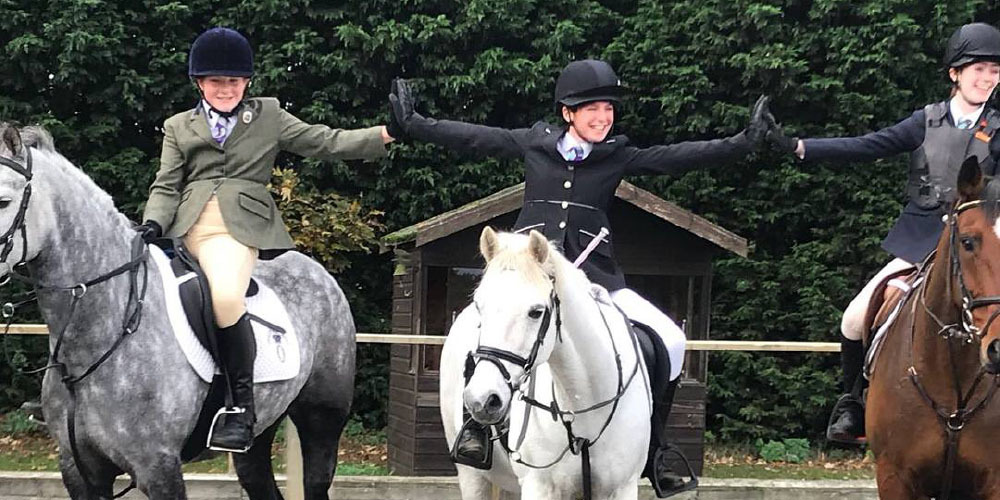 Three people enjoying Pony Club Camp