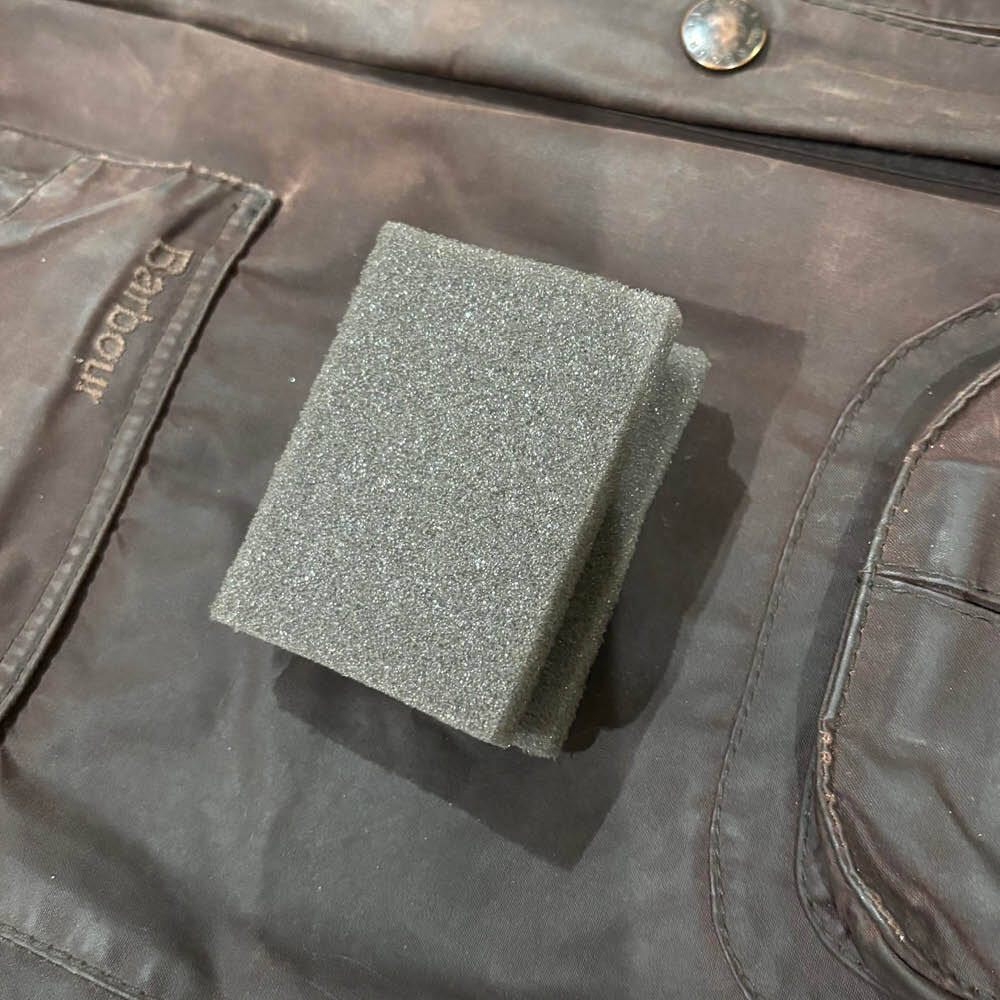 Foam sponge used to spread wax dressing evenly across the front of a Barbour jacket.