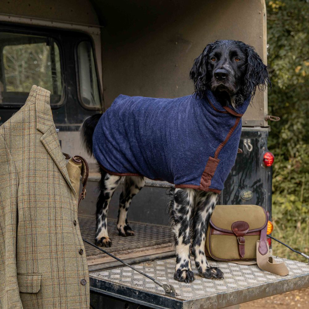 Working dog in back of car wearing the Ruff & Tumble Country Collection Dog Drying Coat 